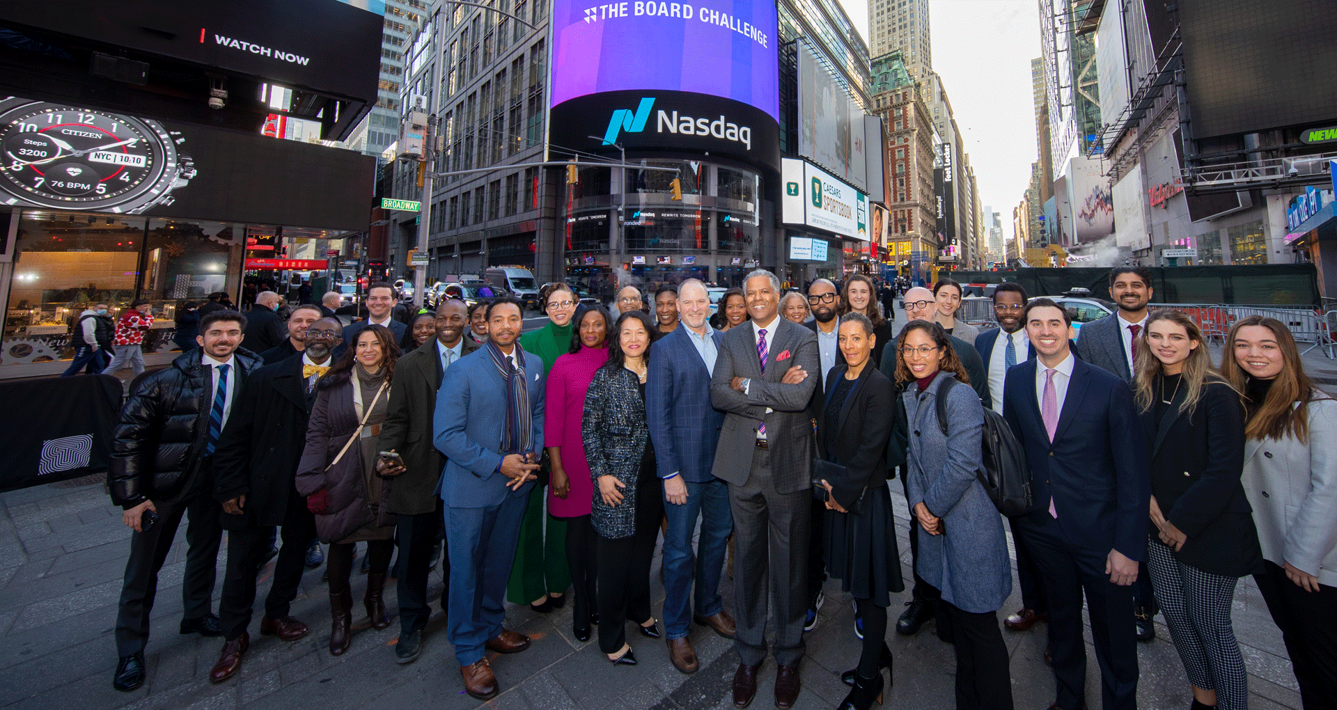 A group photo of The Board Challenge, with Times Square in the back ground.